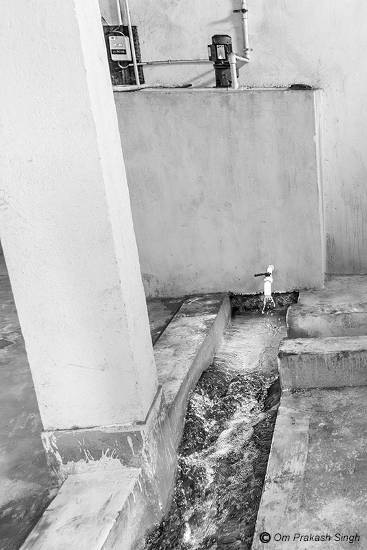 Water from the filtration tank being mixed with bleaching powder solution at the water treatment plant (WTP) of a multi-village scheme under Jal Jeevan Mission in Jharkhand, India